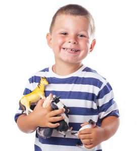 child holding animals toys on a white background